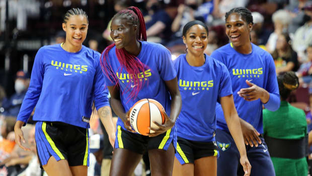 Wings players smile while warming up before their first 2022 playoff game against the Sun.